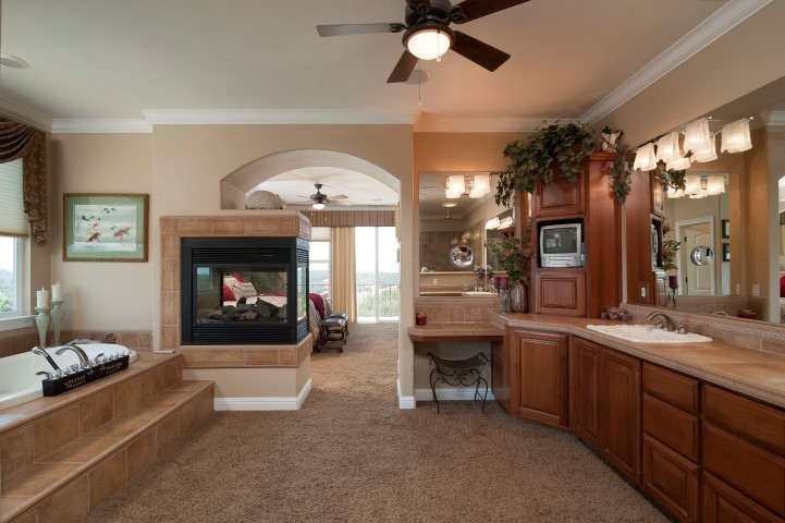 master bath deep jacuzzi tub with private views of the sierras. double-sided fireplace, sit down vanity, double sinks, walk-in closet, walk-in shower with multiple shower heads.