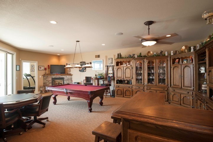 game room includes custom cabinetry, bar and pool table. views and deck access.
