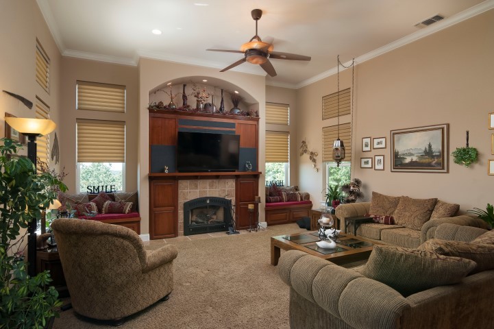 family room great entertainment center with window seats on either side of fireplace. great views and deck access.