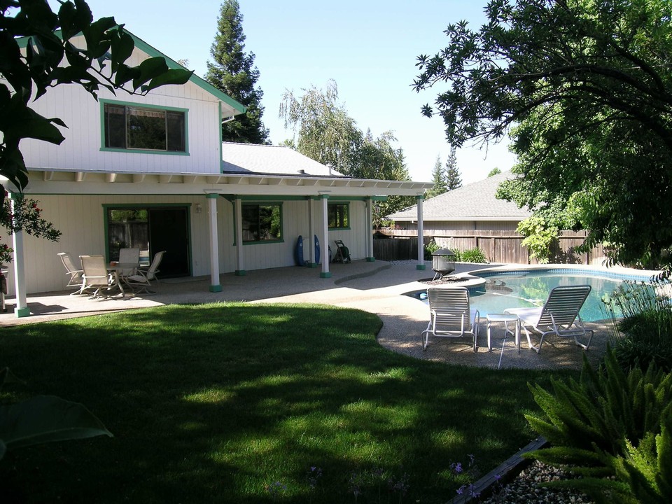 backyard large, beautiful, mature backyard with built in swimming pool and patio cover for entertaining.