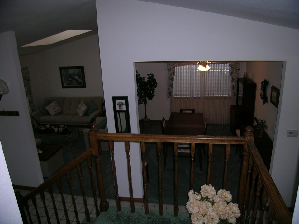 stairway view looking down into the living room and formal dining area.